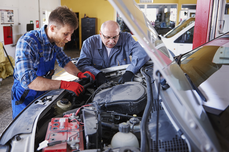 mechanics-repairing-a-car-in-the-workshop.jpg