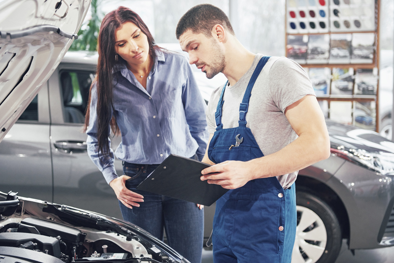 a-man-mechanic-and-woman-customer-discussing-repairs-done-to-her-vehicle.jpg