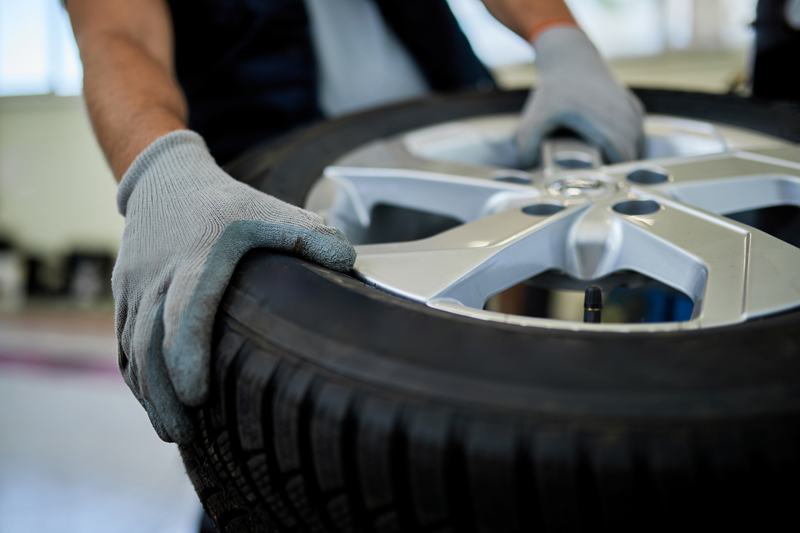 closeup-of-a-mechanic-working-with-car-tire-in-auto-repair-shop.jpg