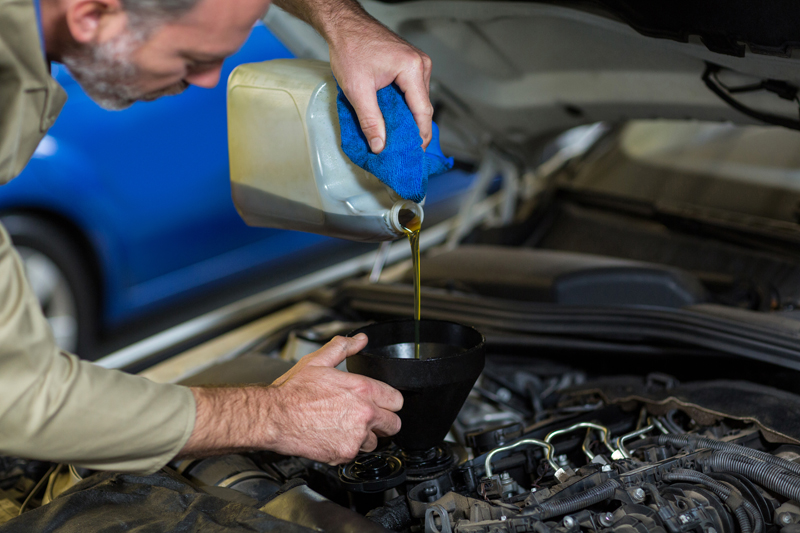 mechanic-pouring-oil-into-car-engine.jpg