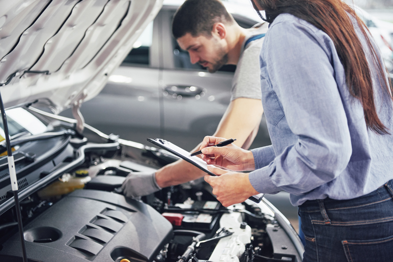 a-man-mechanic-and-woman-customer-look-at-the-car-hood-and-discuss-repairs.jpg